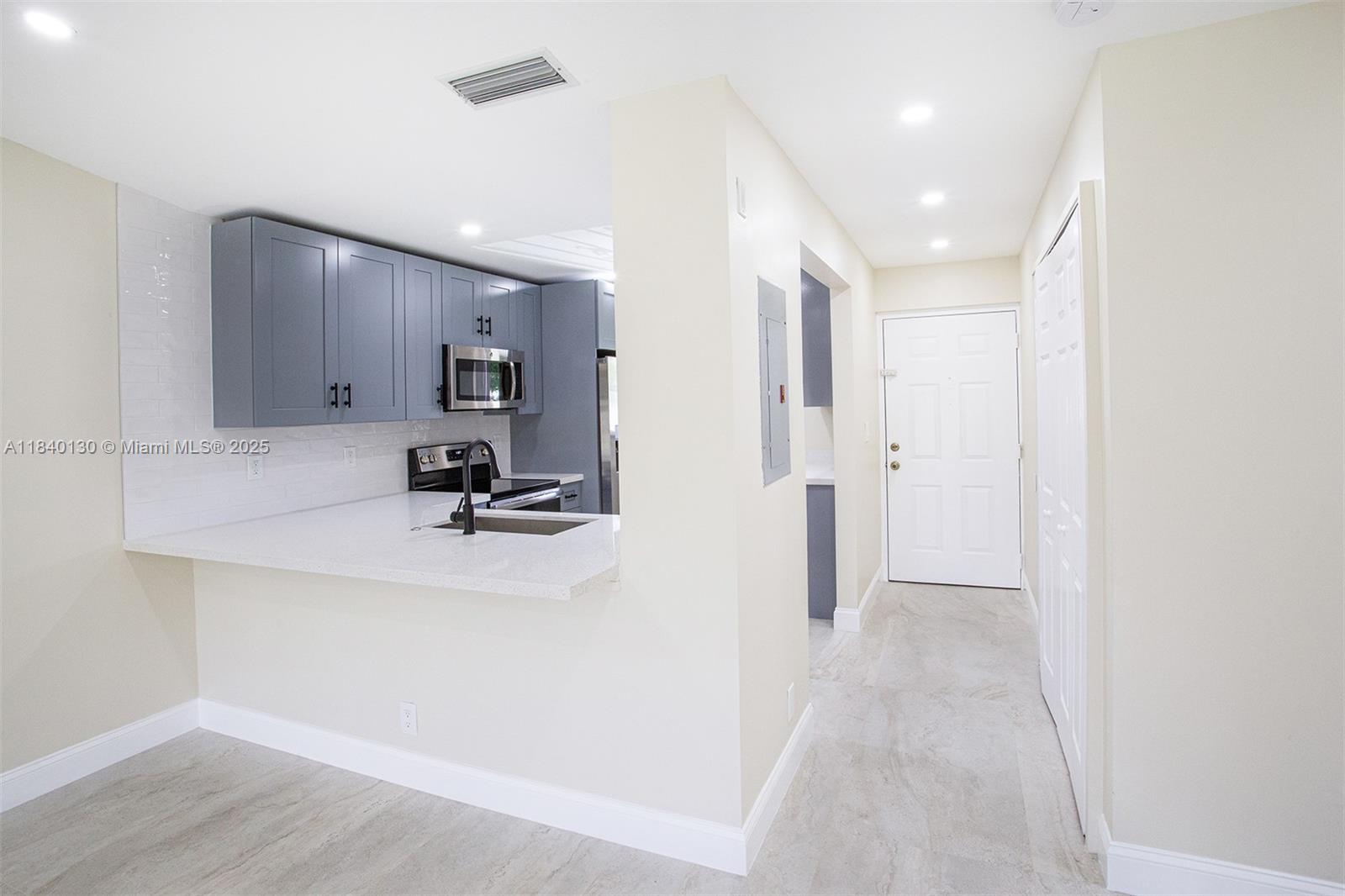 9431 Boca Cove Circle, Unit 1009 Boca Raton, FL 33428 - Photo 7 of 30 a view of a bathroom with a sink and mirror
