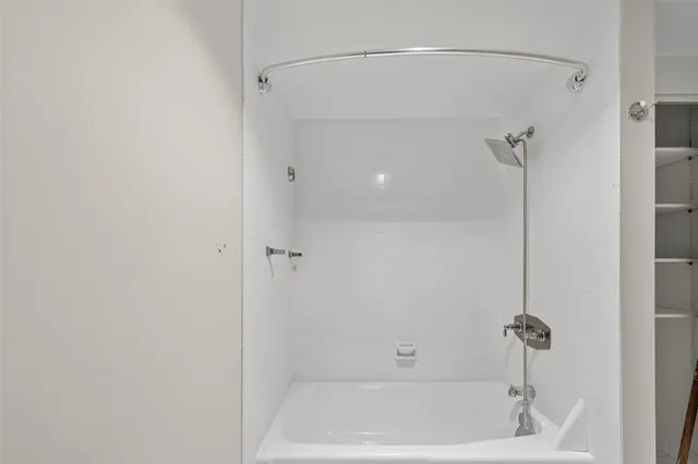 a bathroom with a shower and a bath tub