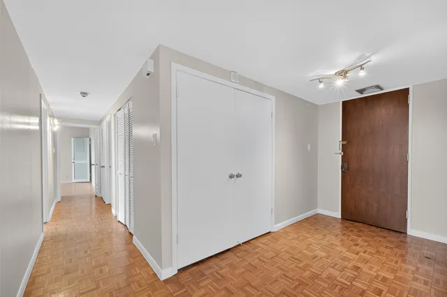 a view of a hallway with wooden floor