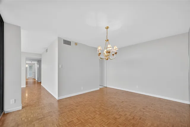 a view of empty room with a chandelier fan