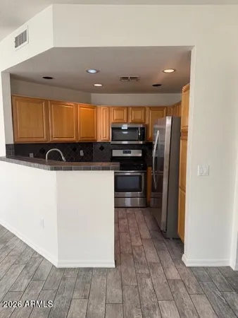 a kitchen with stainless steel appliances a refrigerator and a stove