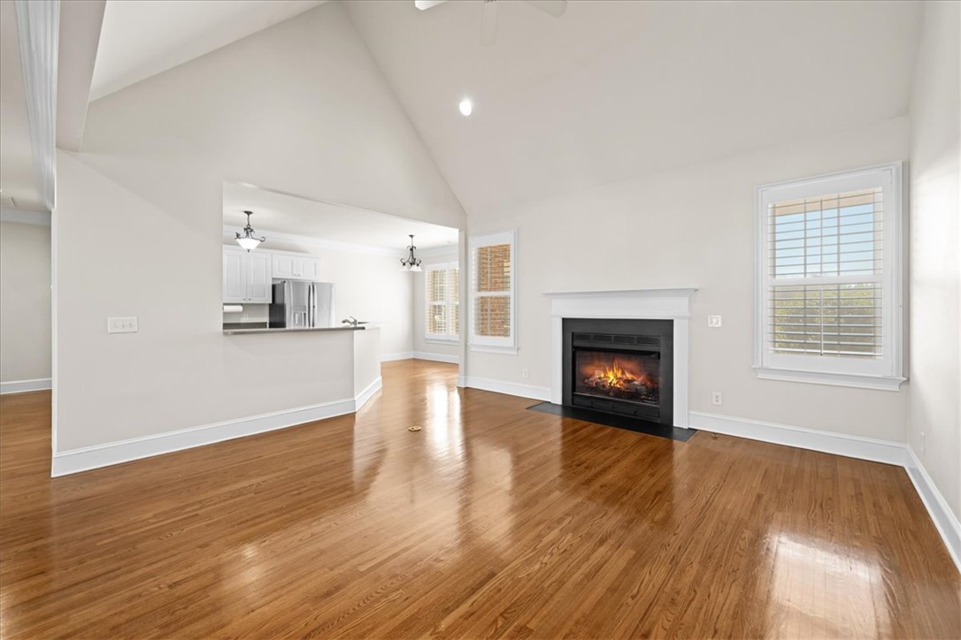 38 Angus Run Seneca, SC 29672 - Photo 9 of 46 This bright living area features a warm fireplace and polished wood floors, connecting seamlessly to the kitchen.