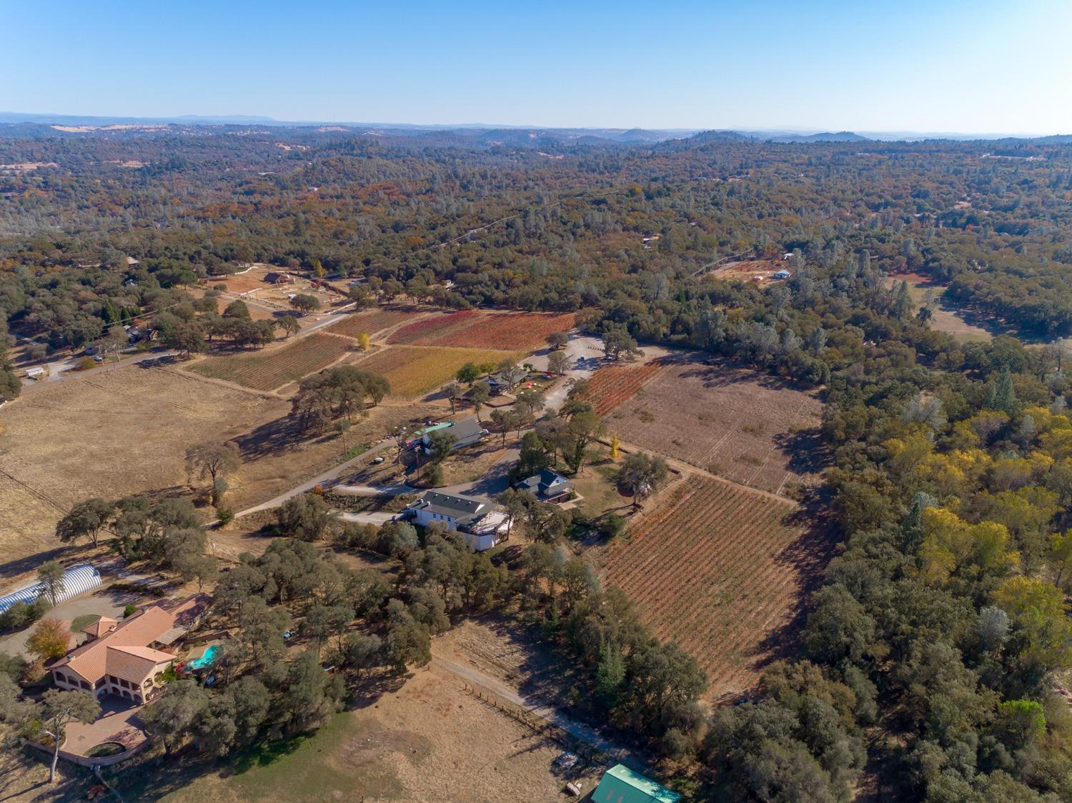 an aerial view of house with yard and mountain view in back