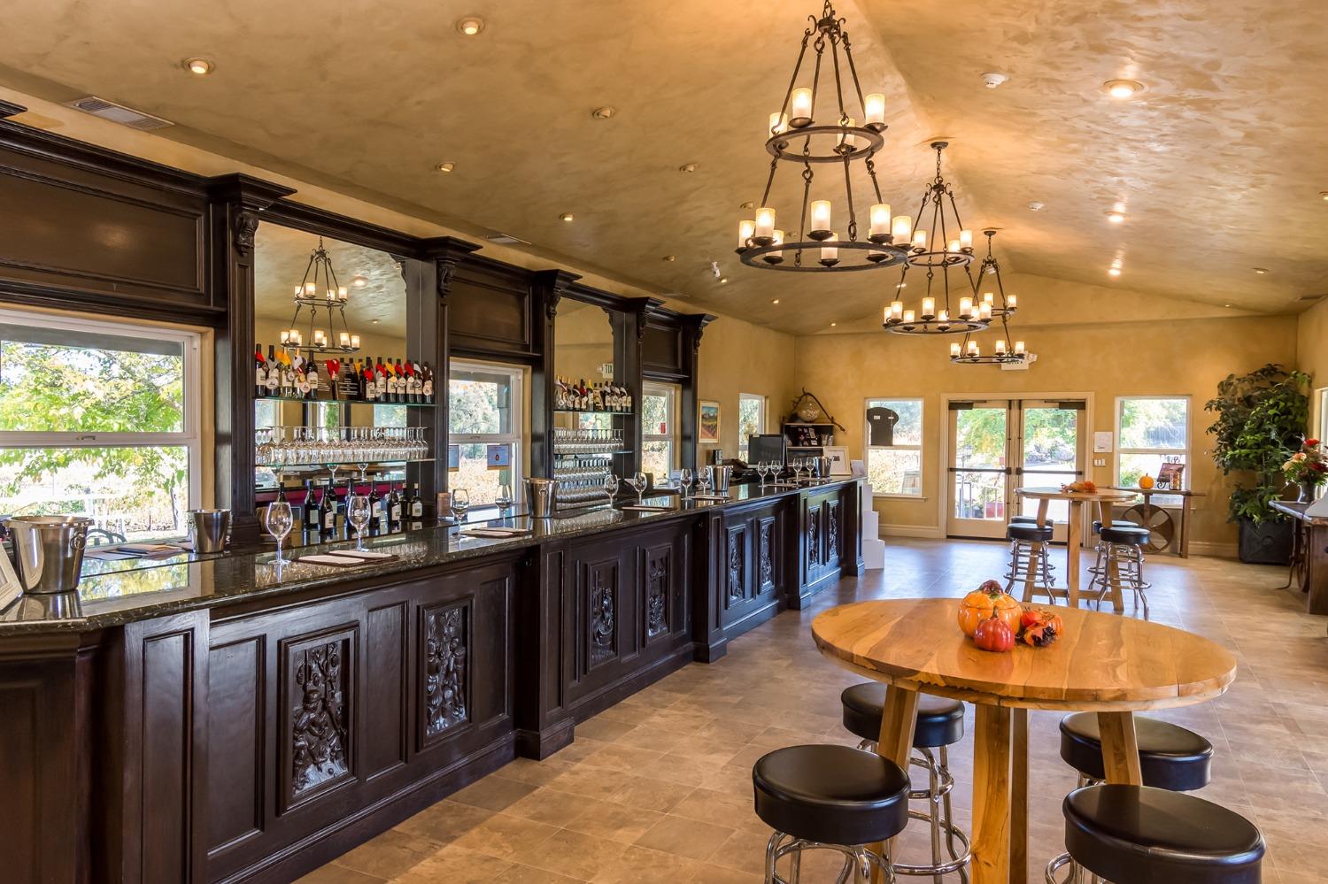 3040 Ponderosa Road Shingle Springs, CA 95682 - Photo 13 of 52 a kitchen with stainless steel appliances granite countertop a dining table and chairs with wooden floor