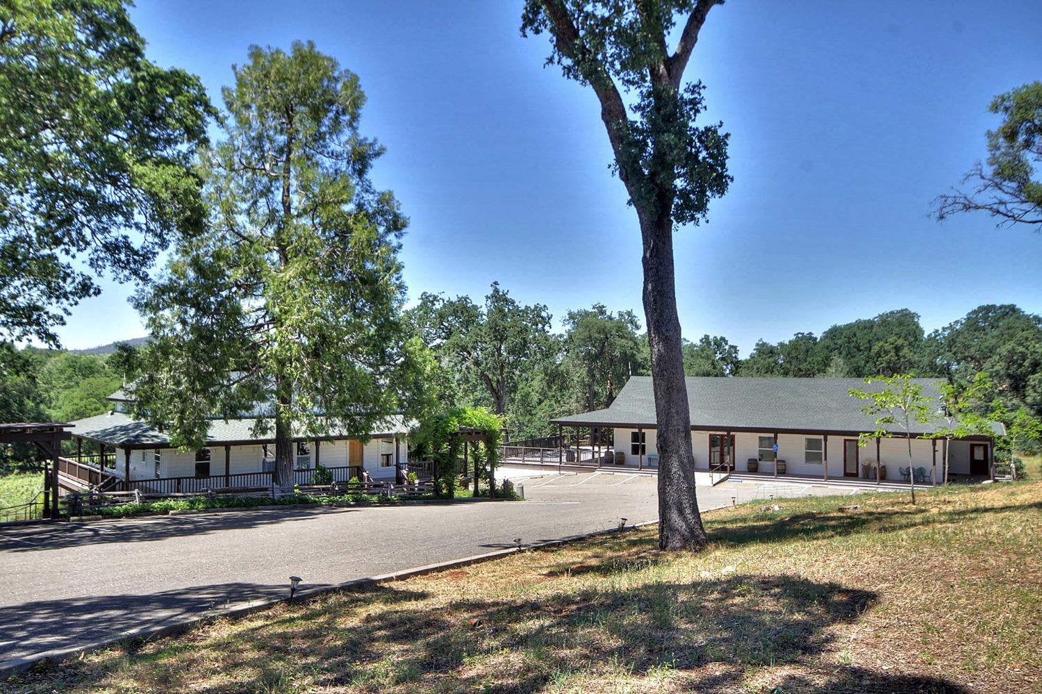 3040 Ponderosa Road Shingle Springs, CA 95682 - Photo 37 of 52 a view of a house with large tree next to a yard