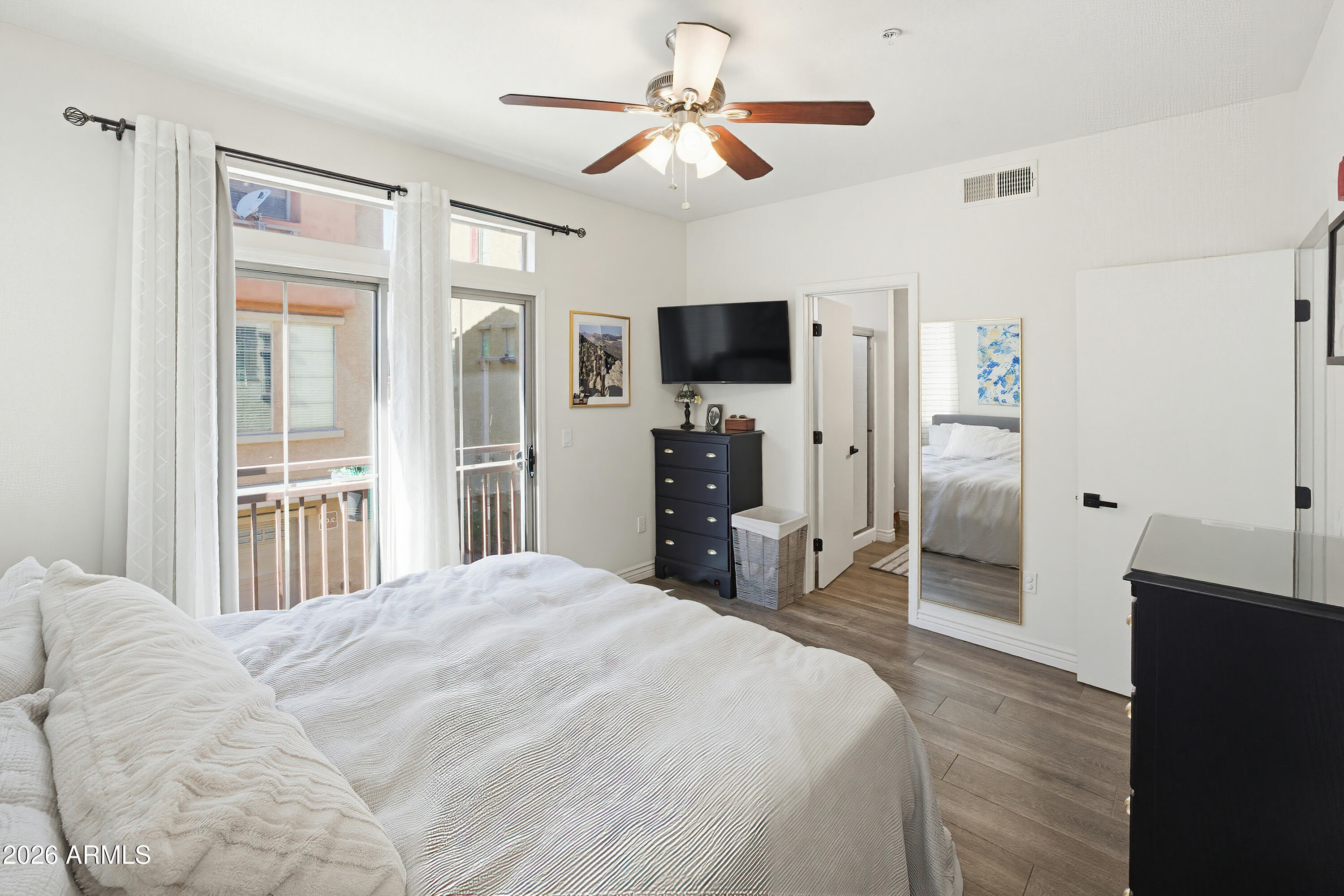 3250 West Greenway Road, Unit 162 Phoenix, AZ 85053 - Photo 11 of 31 a bedroom with a bed and a flat screen tv