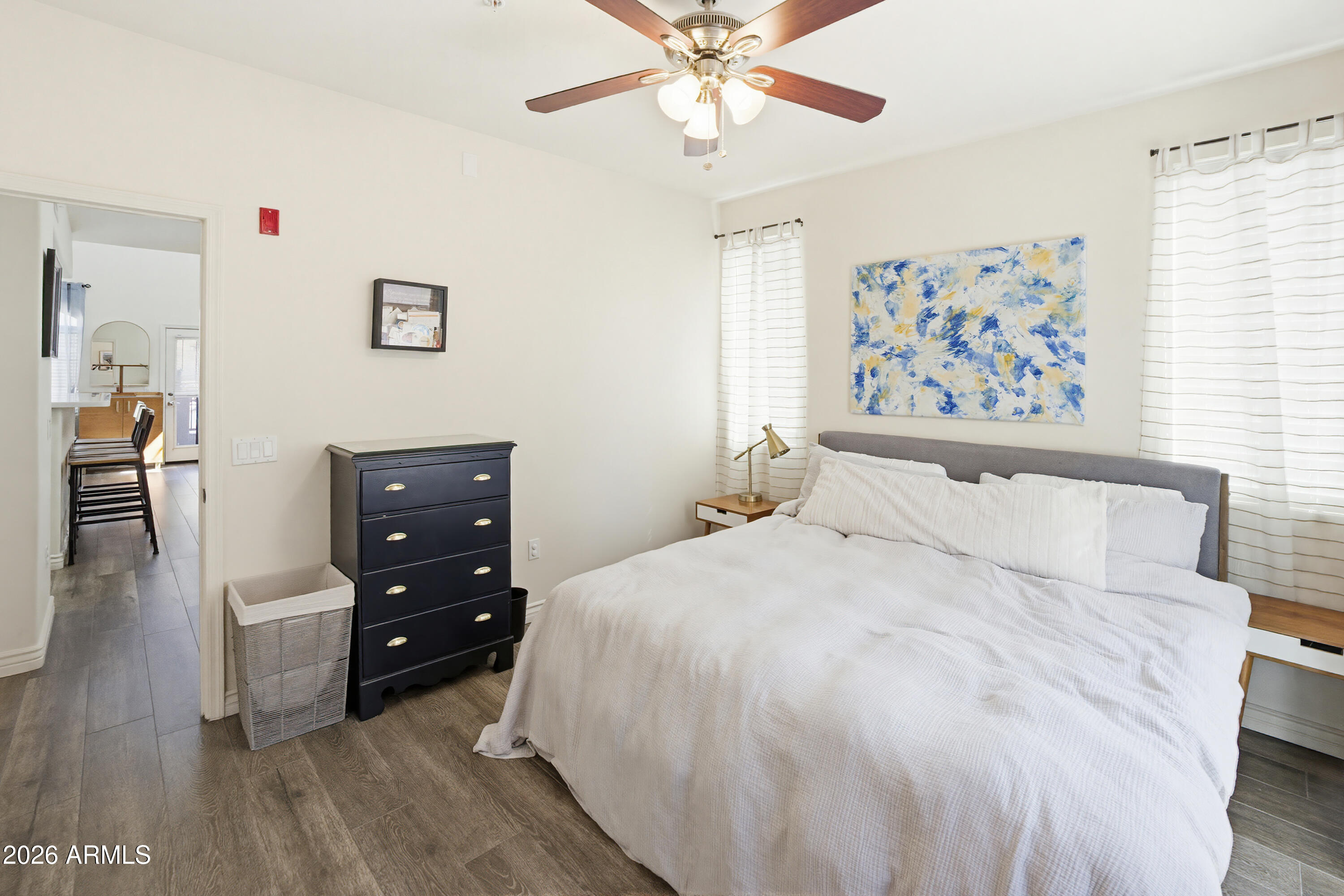 3250 West Greenway Road, Unit 162 Phoenix, AZ 85053 - Photo 12 of 31 a spacious bedroom with a bed and a chandelier