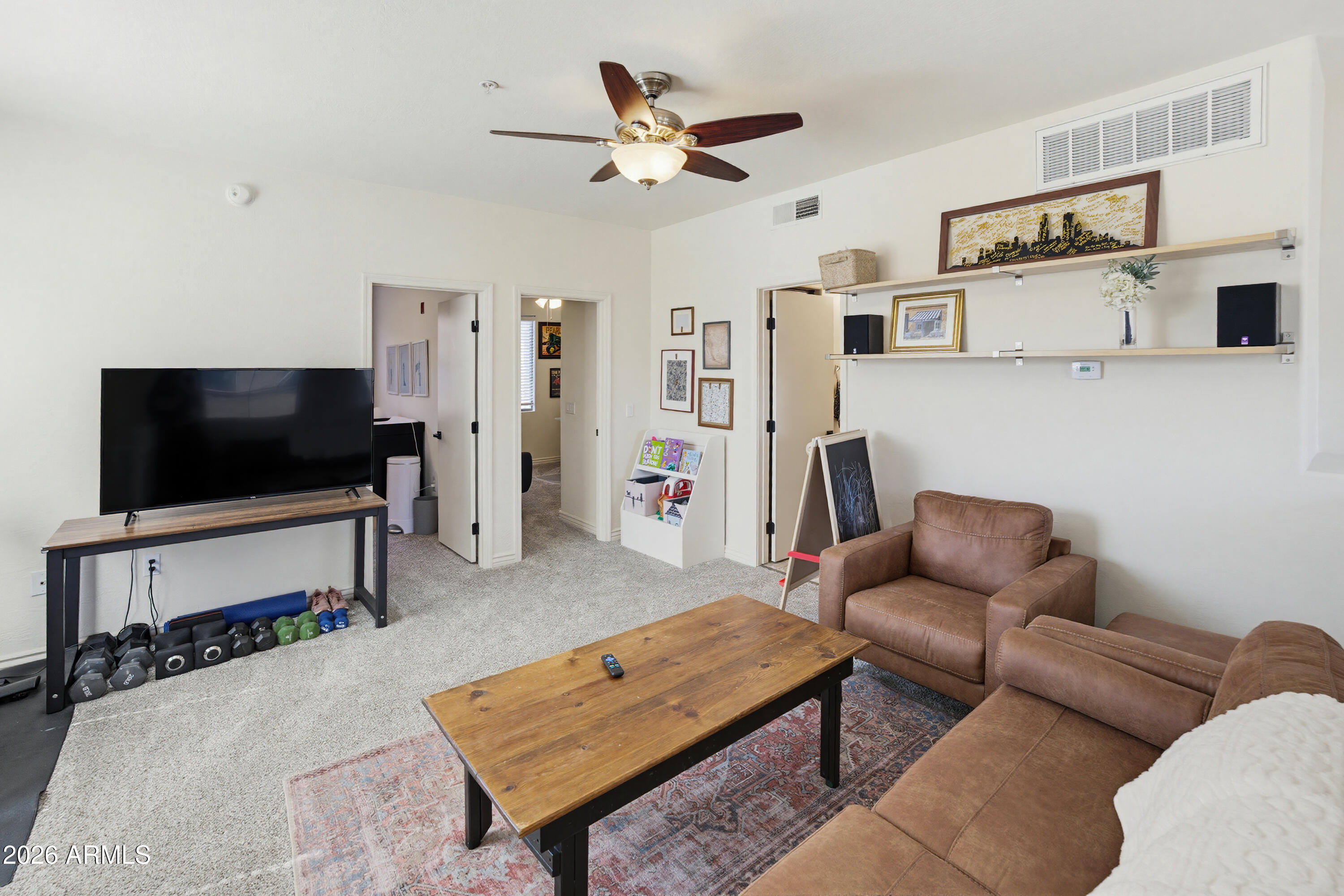 3250 West Greenway Road, Unit 162 Phoenix, AZ 85053 - Photo 15 of 31 a living room with furniture and a flat screen tv
