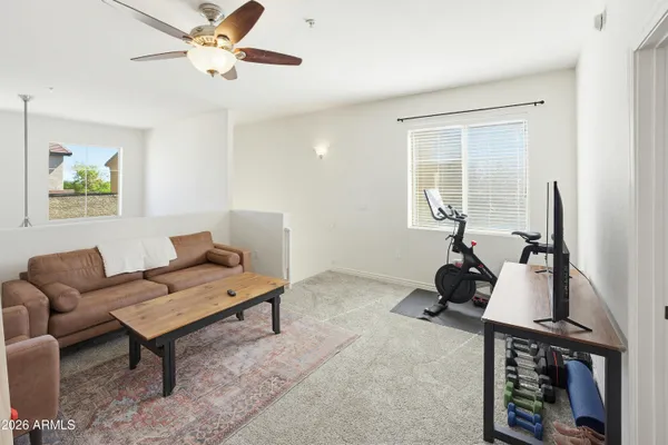 a living room with furniture a rug and a window