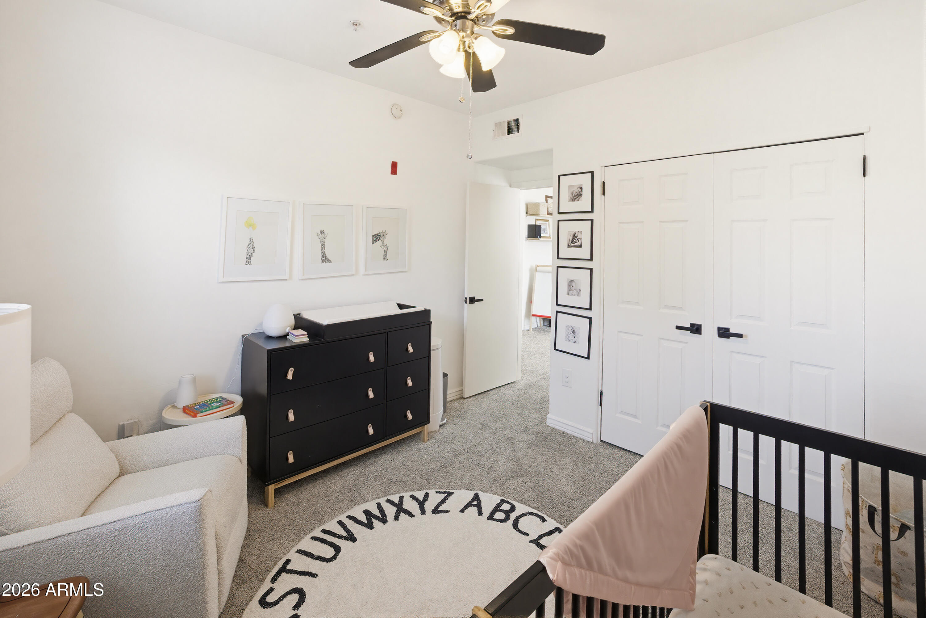 3250 West Greenway Road, Unit 162 Phoenix, AZ 85053 - Photo 20 of 31 a living room with a couch and a chandelier