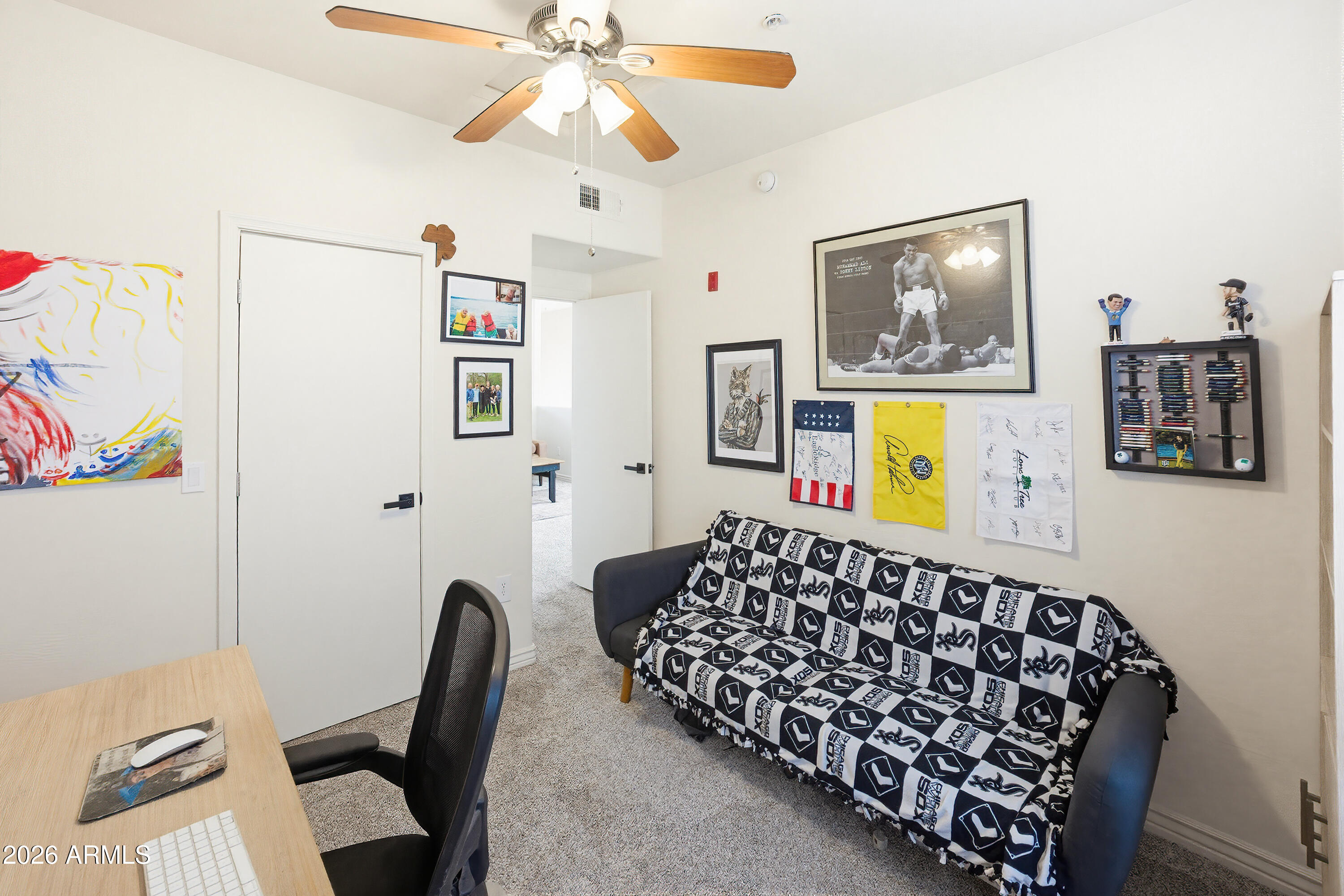 3250 West Greenway Road, Unit 162 Phoenix, AZ 85053 - Photo 23 of 31 a bedroom with a bed and a chandelier
