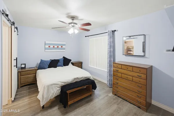 a bedroom with a bed and cabinet