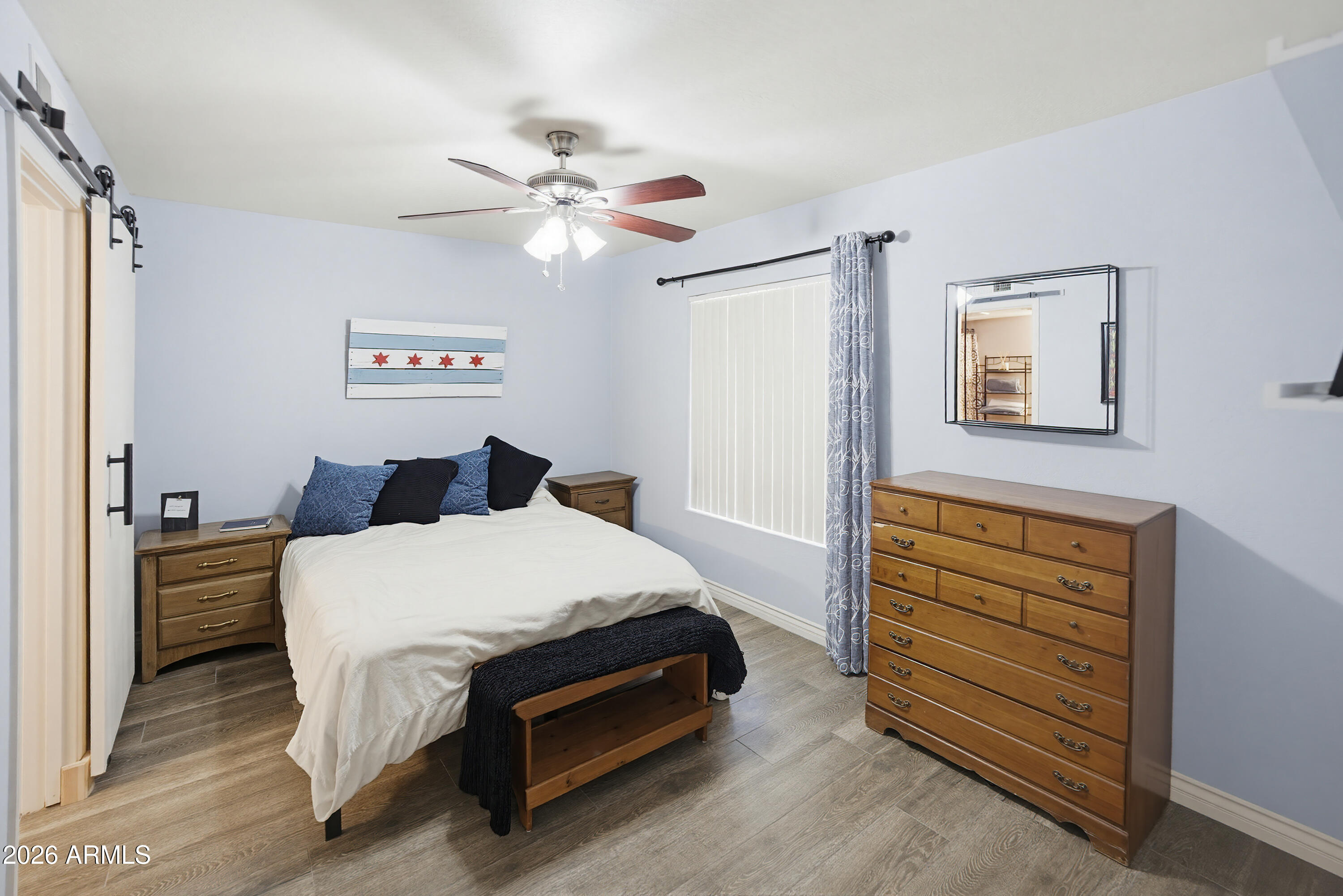 3250 West Greenway Road, Unit 162 Phoenix, AZ 85053 - Photo 25 of 31 a bedroom with a bed and cabinet