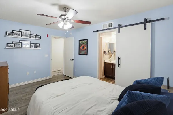 a bedroom with a bed and a chandelier