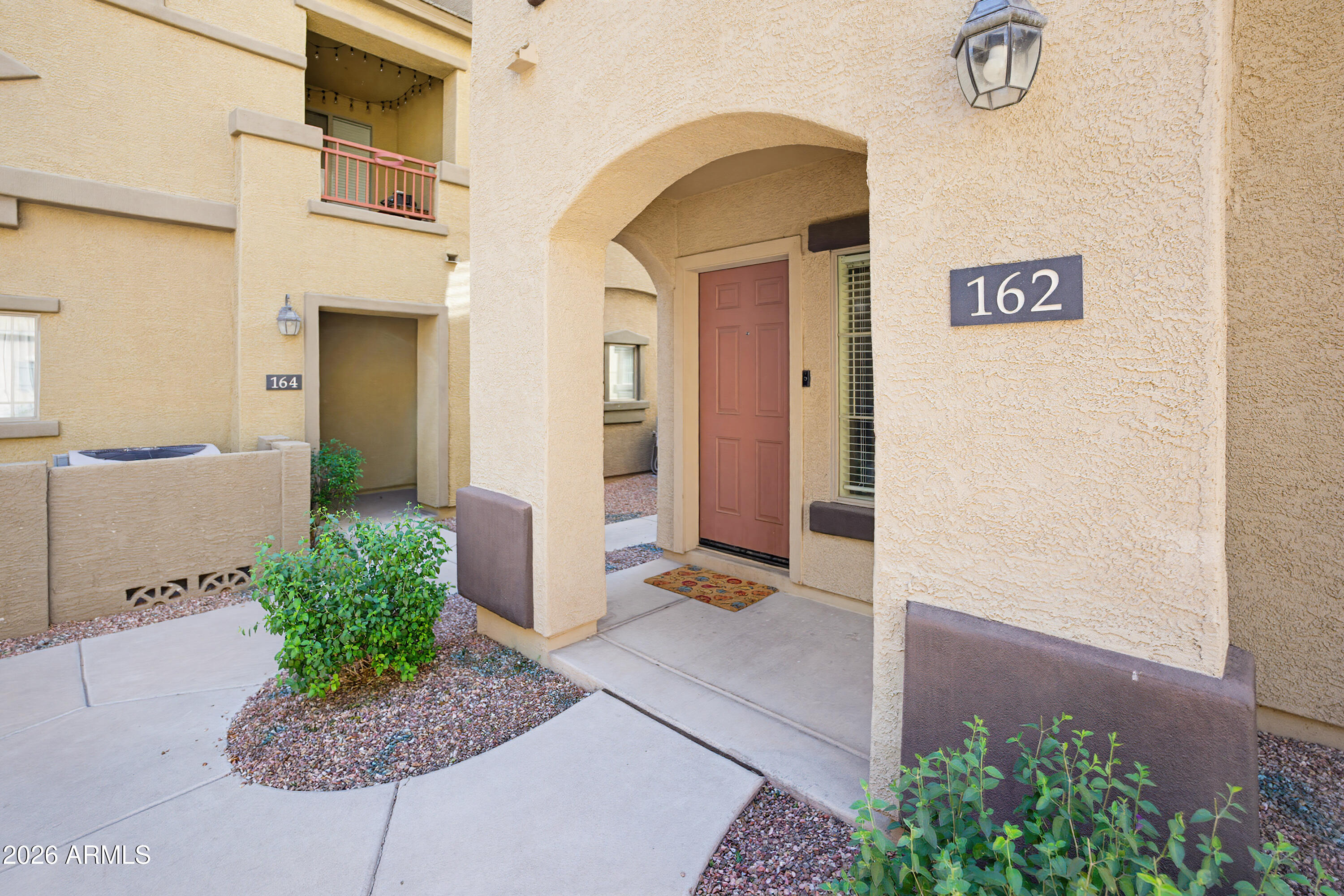 3250 West Greenway Road, Unit 162 Phoenix, AZ 85053 - Photo 29 of 31 a front view of a house with garden