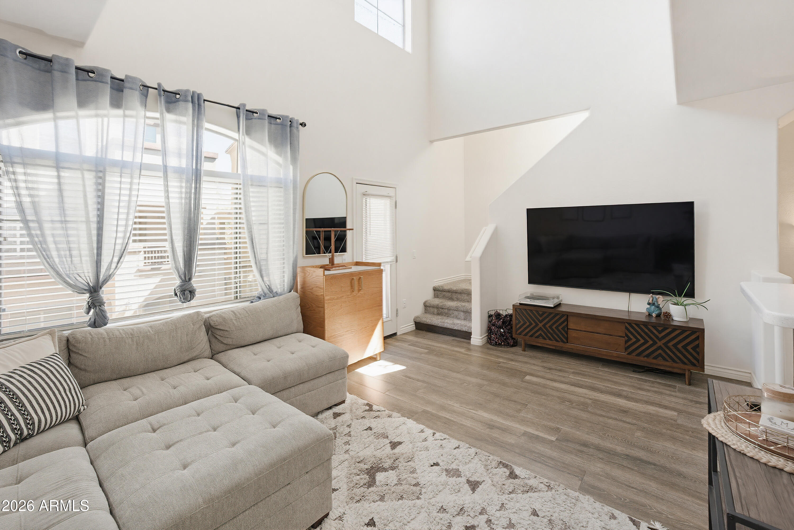 3250 West Greenway Road, Unit 162 Phoenix, AZ 85053 - Photo 3 of 31 a living room with furniture and a flat screen tv