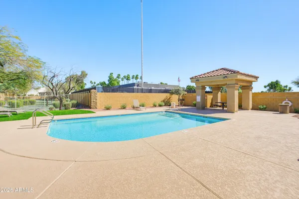 a view of a swimming pool with an outdoor seating and a yard