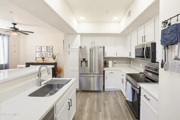 a kitchen with a sink stove and refrigerator
