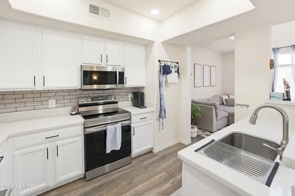 a kitchen with a sink stove and refrigerator