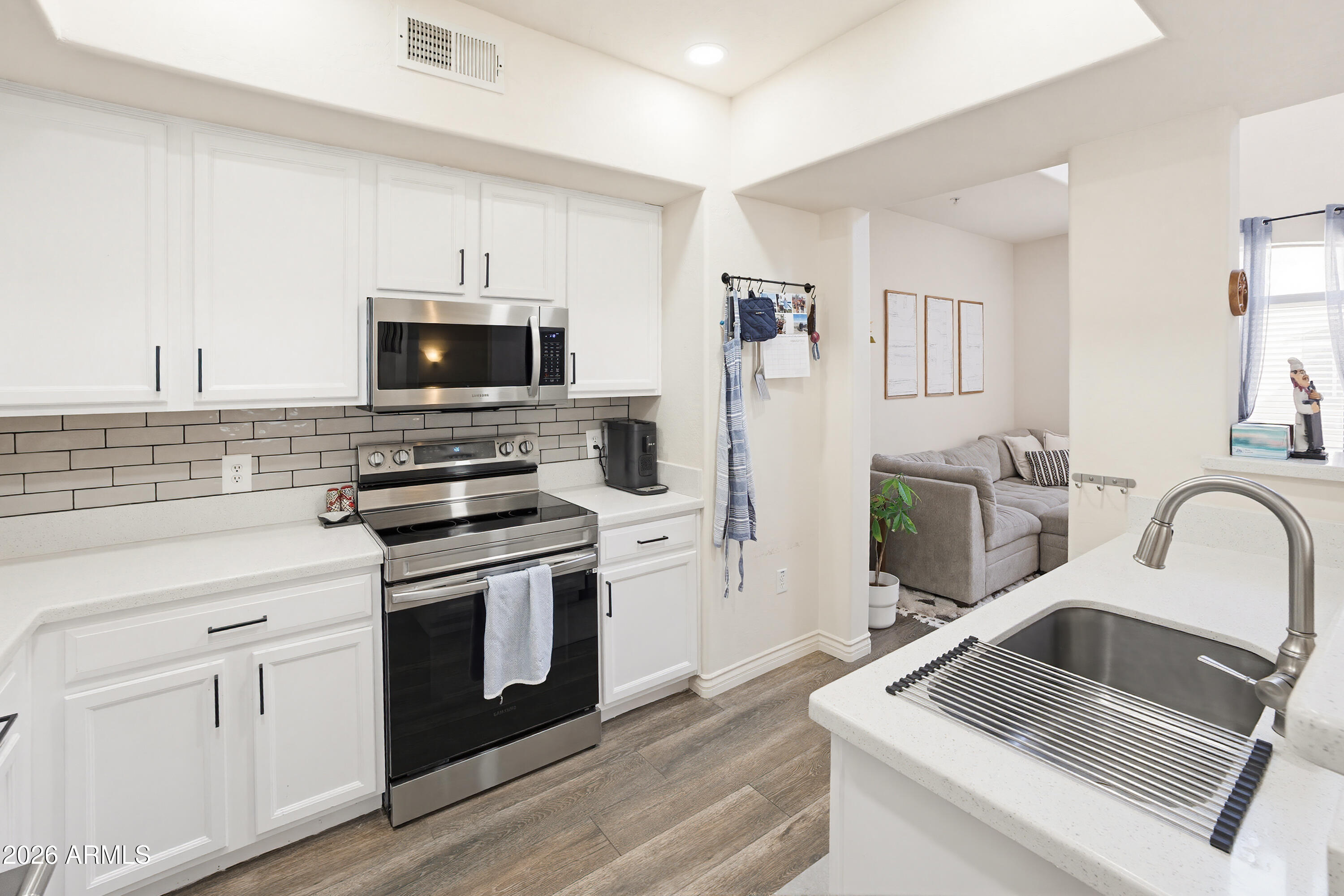 3250 West Greenway Road, Unit 162 Phoenix, AZ 85053 - Photo 5 of 31 a kitchen with a sink stove and refrigerator
