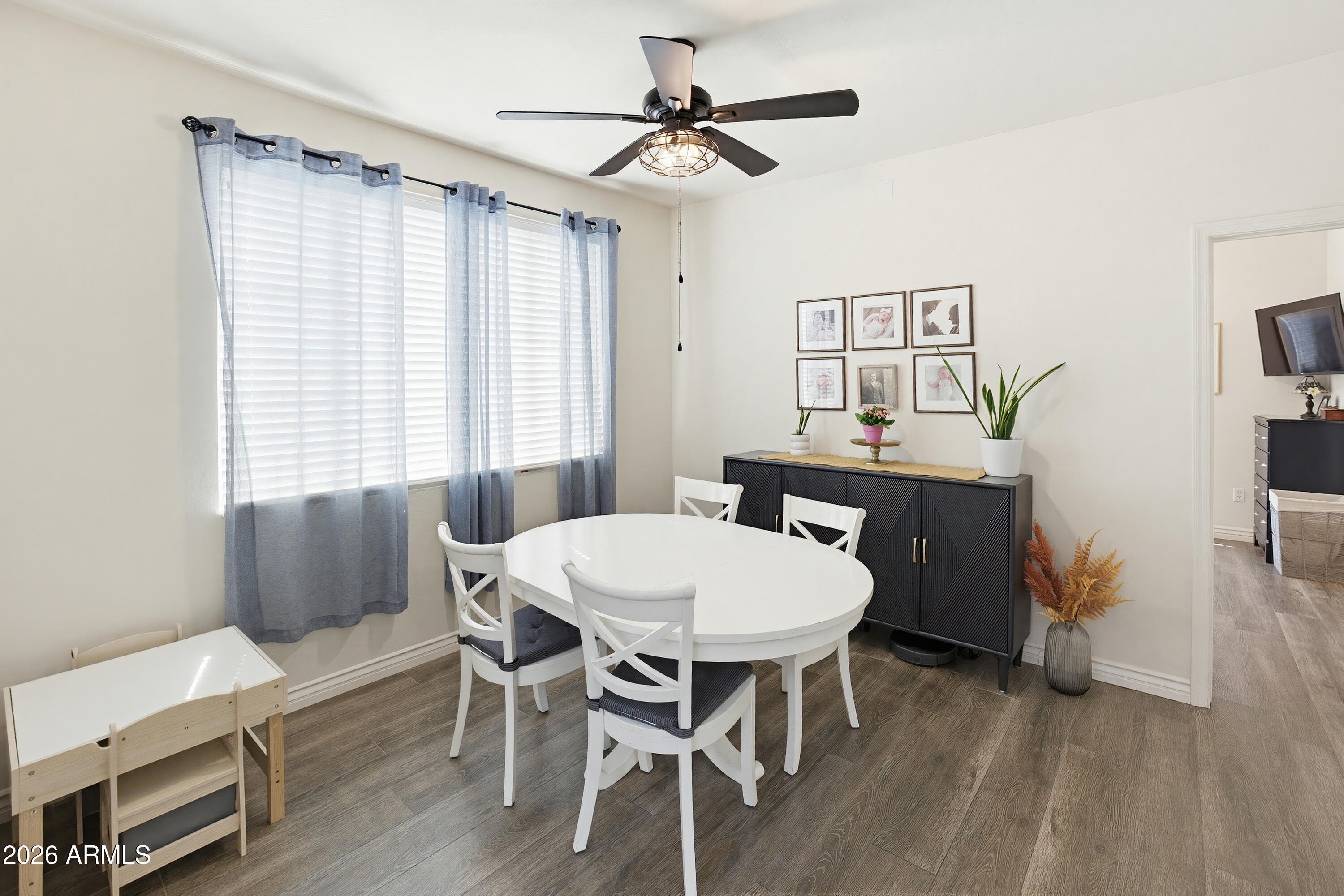 3250 West Greenway Road, Unit 162 Phoenix, AZ 85053 - Photo 8 of 31 a view of a dining room with furniture window and wooden floor