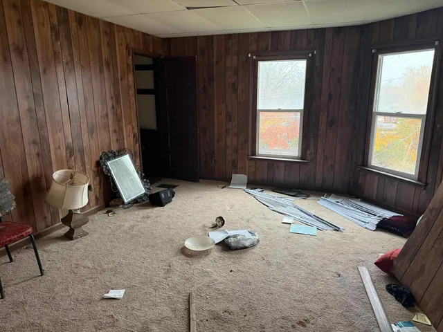 a bed sitting in a room next to a window