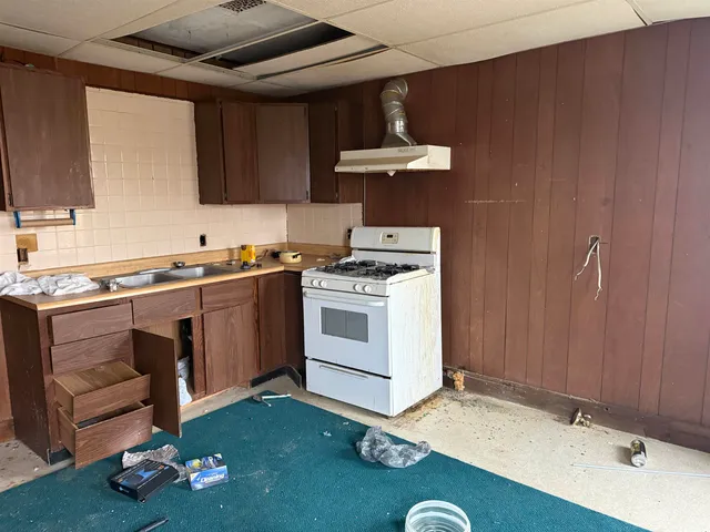 a kitchen with a sink stove and cabinets
