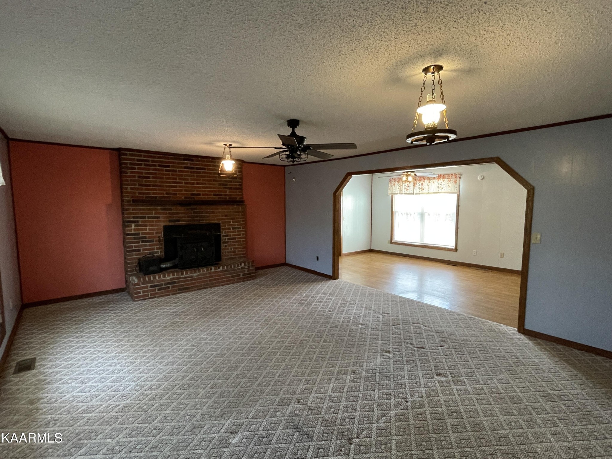 2360 Roslin Road Clarkrange, TN 38553 - Photo 25 of 58 an empty room with a fireplace and fan