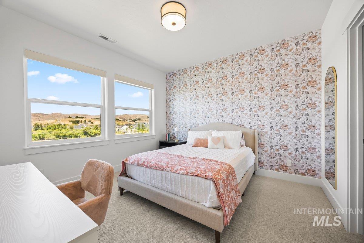 13746 North Ruffed Grouse Way Boise, ID 83714 - Photo 26 of 43 Carpeted bedroom featuring wallpapered walls and baseboards