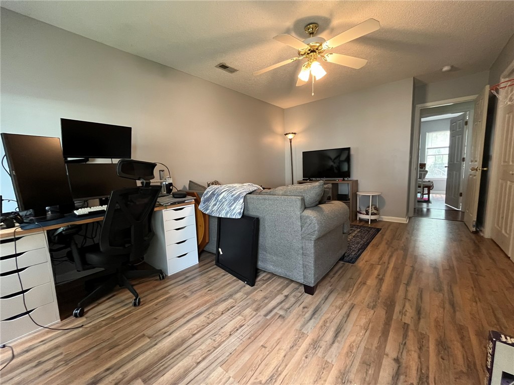 116 Arbors Court Central, SC 29630 - Photo 25 of 27 A versatile living area with warm wood flooring and convenient entry access.