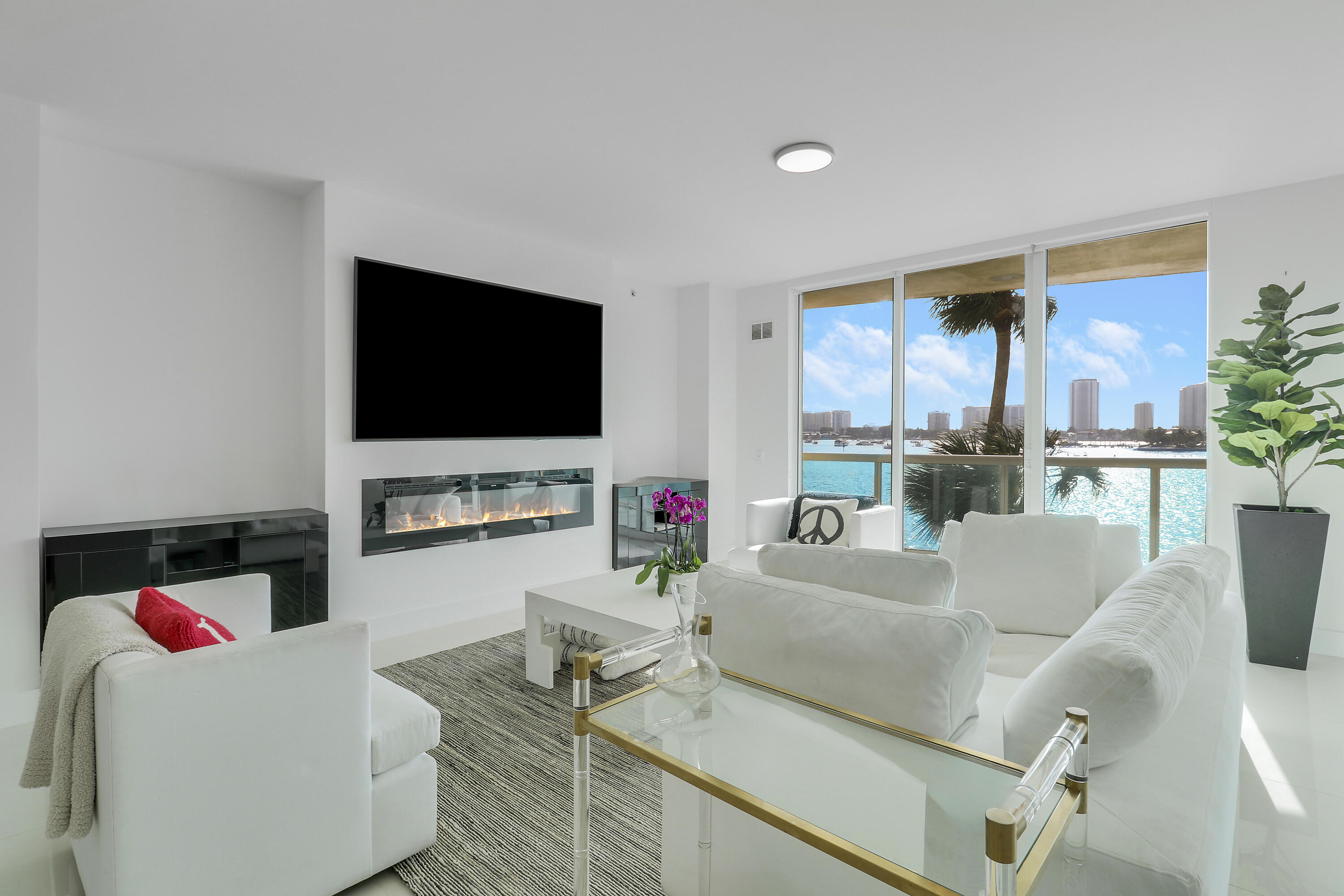 2640 Lake Shore Drive, Unit 307 Riviera Beach, FL 33404 - Photo 7 of 44 a living room with furniture and a flat screen tv