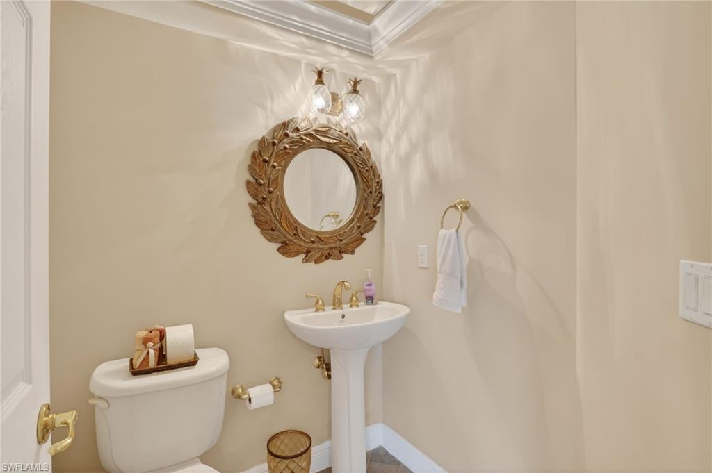 1964 Rialto Way Alva, FL 33920 - Photo 31 of 50 a bathroom with a toilet sink and mirror