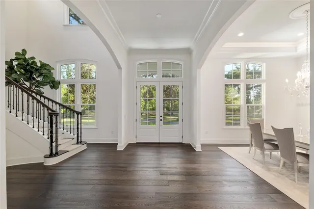 a kitchen that has a lot of cabinets in it and wooden floors
