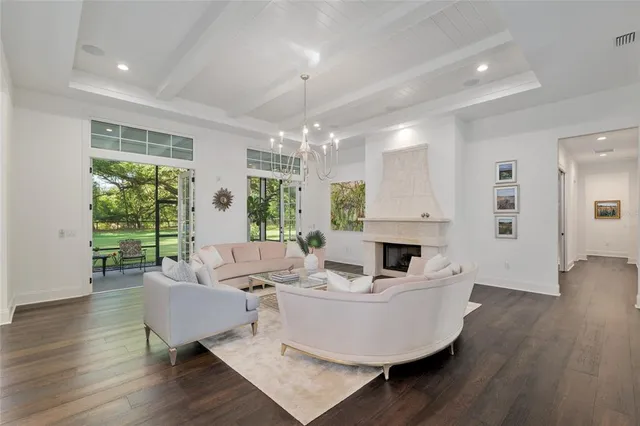 a view of a dining room with furniture and a chandelier