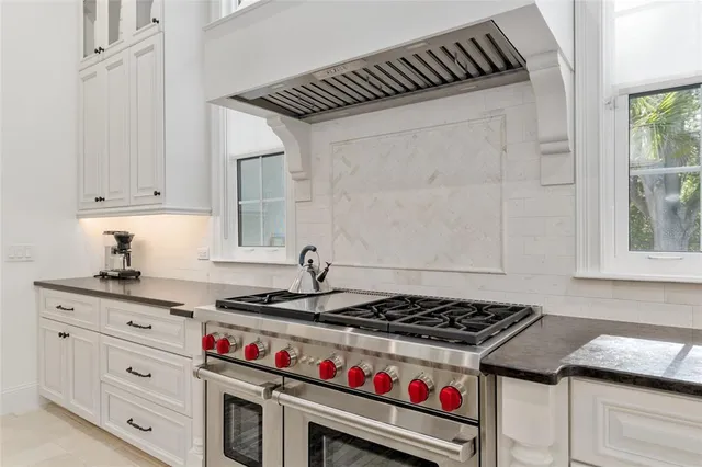 a living room with patio furniture and a floor to ceiling window