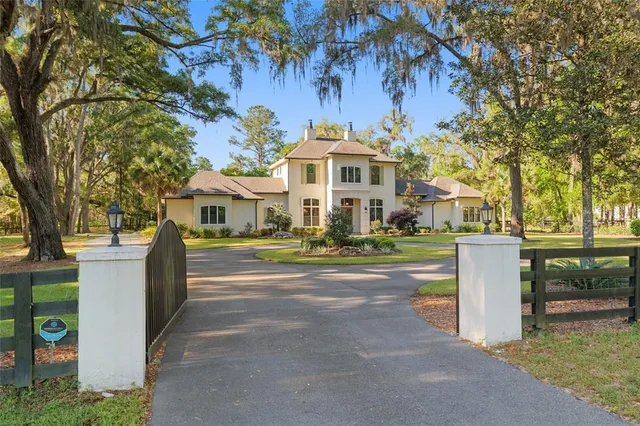 a living room with fireplace furniture and a large window