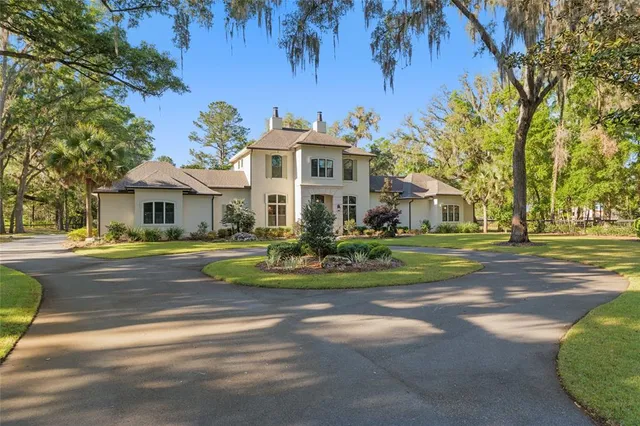 a living room with fireplace furniture and a large window