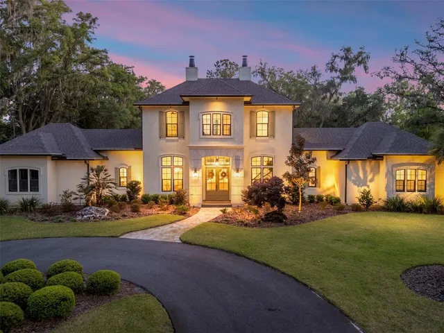 a living room with fireplace furniture and a chandelier