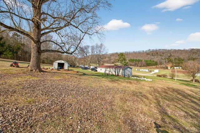 a view of a house with a yard and sitting area