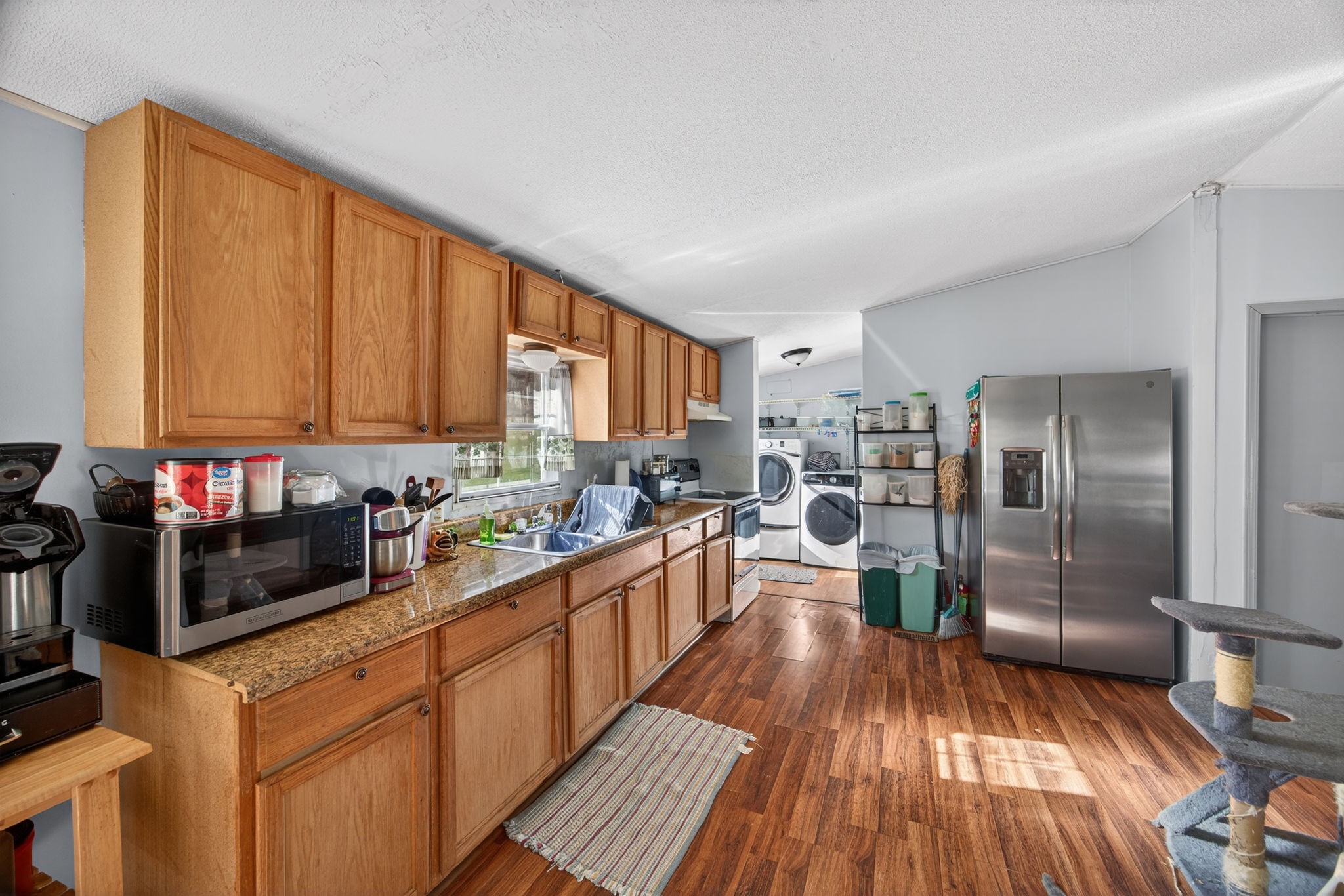 301 Morris Demps Road Sparta, TN 38583 - Photo 8 of 33 a kitchen with stainless steel appliances kitchen island granite countertop a refrigerator stove top oven and sink