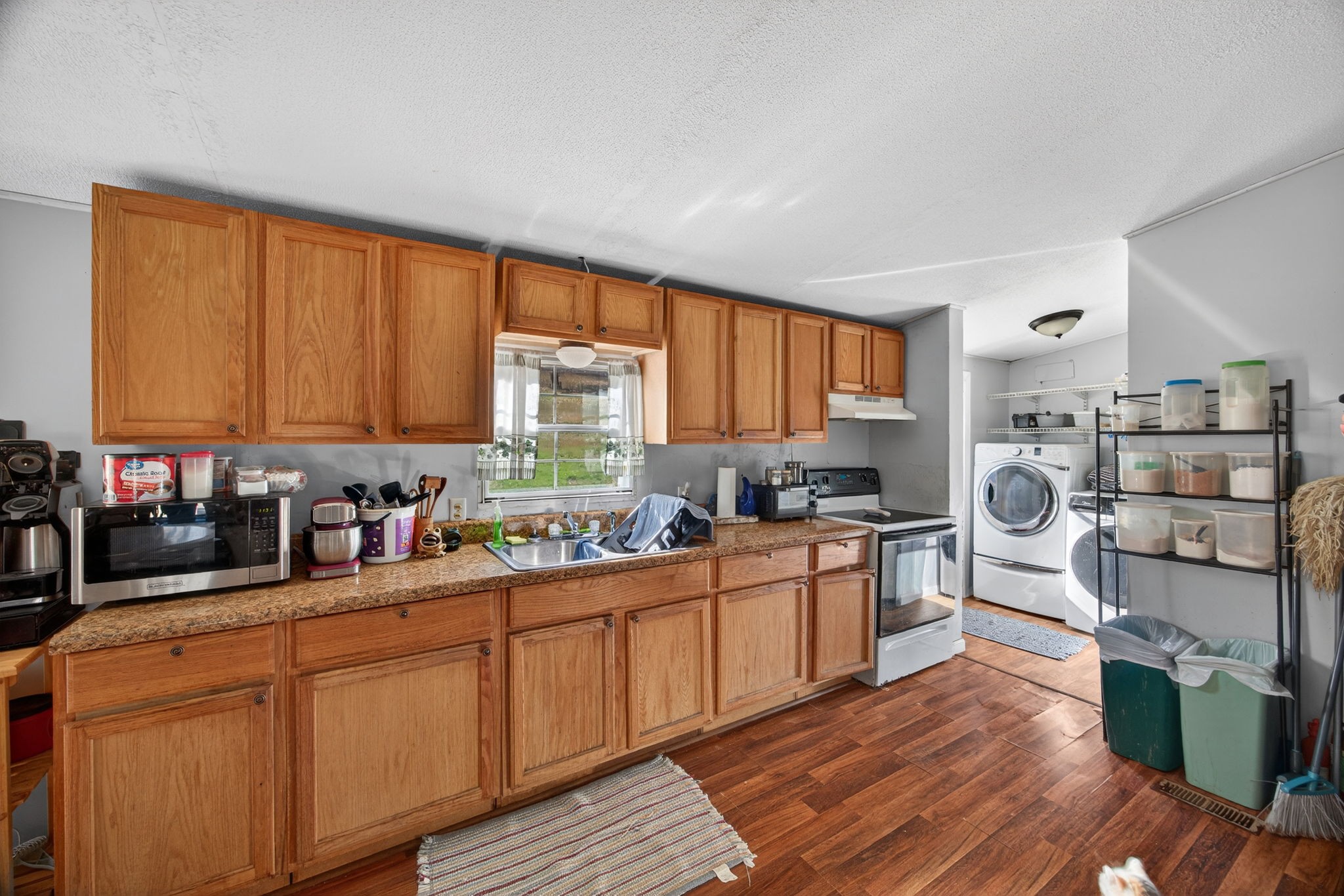 301 Morris Demps Road Sparta, TN 38583 - Photo 9 of 33 a kitchen with stainless steel appliances granite countertop wooden cabinets a stove a sink and dishwasher with wooden floor