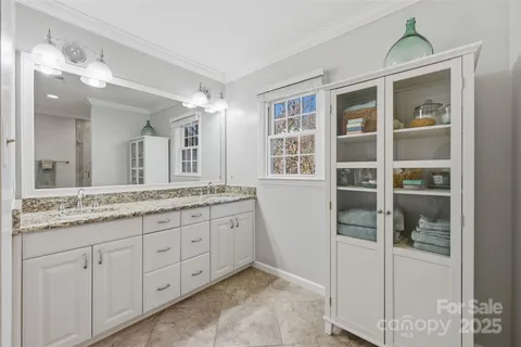 a bathroom with a granite countertop sink and mirror