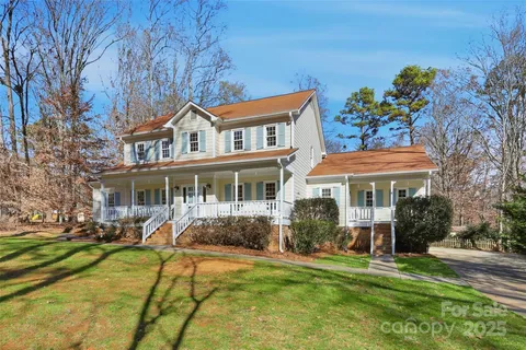 a front view of a house with a yard table and chairs