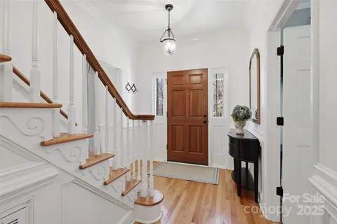a view of entryway and hall with wooden floor