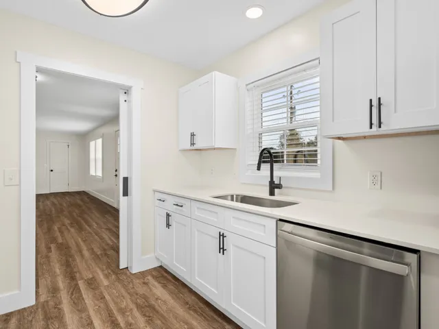 a kitchen with a sink cabinets and window