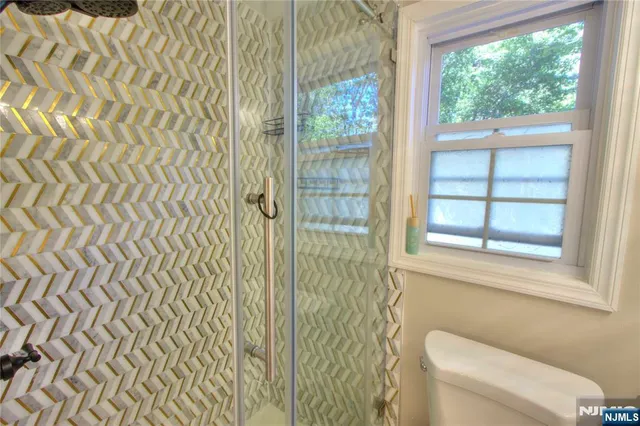 a bathroom with a toilet and a shower curtain