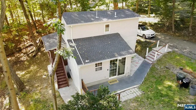 an aerial view of a house with swimming pool and porch