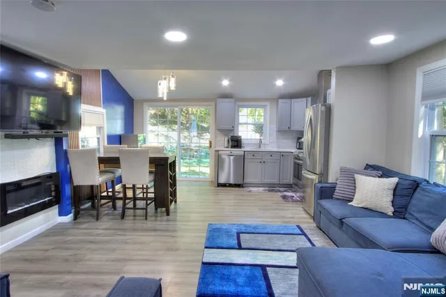 a living room with furniture and kitchen view