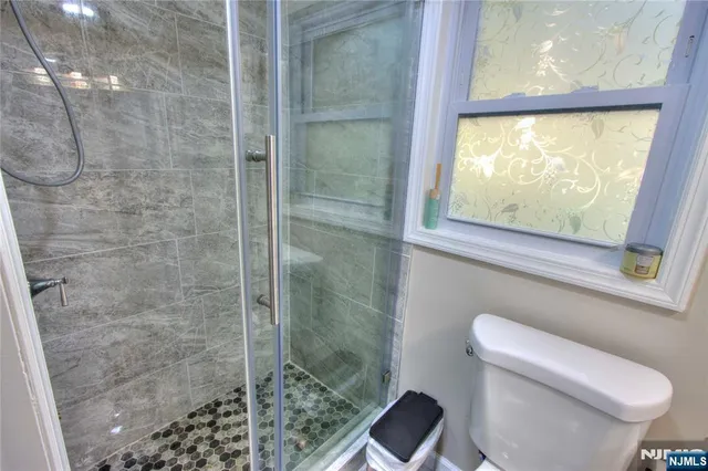 a bathroom with a toilet and a shower