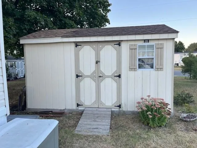 a view of a house with a wooden fence